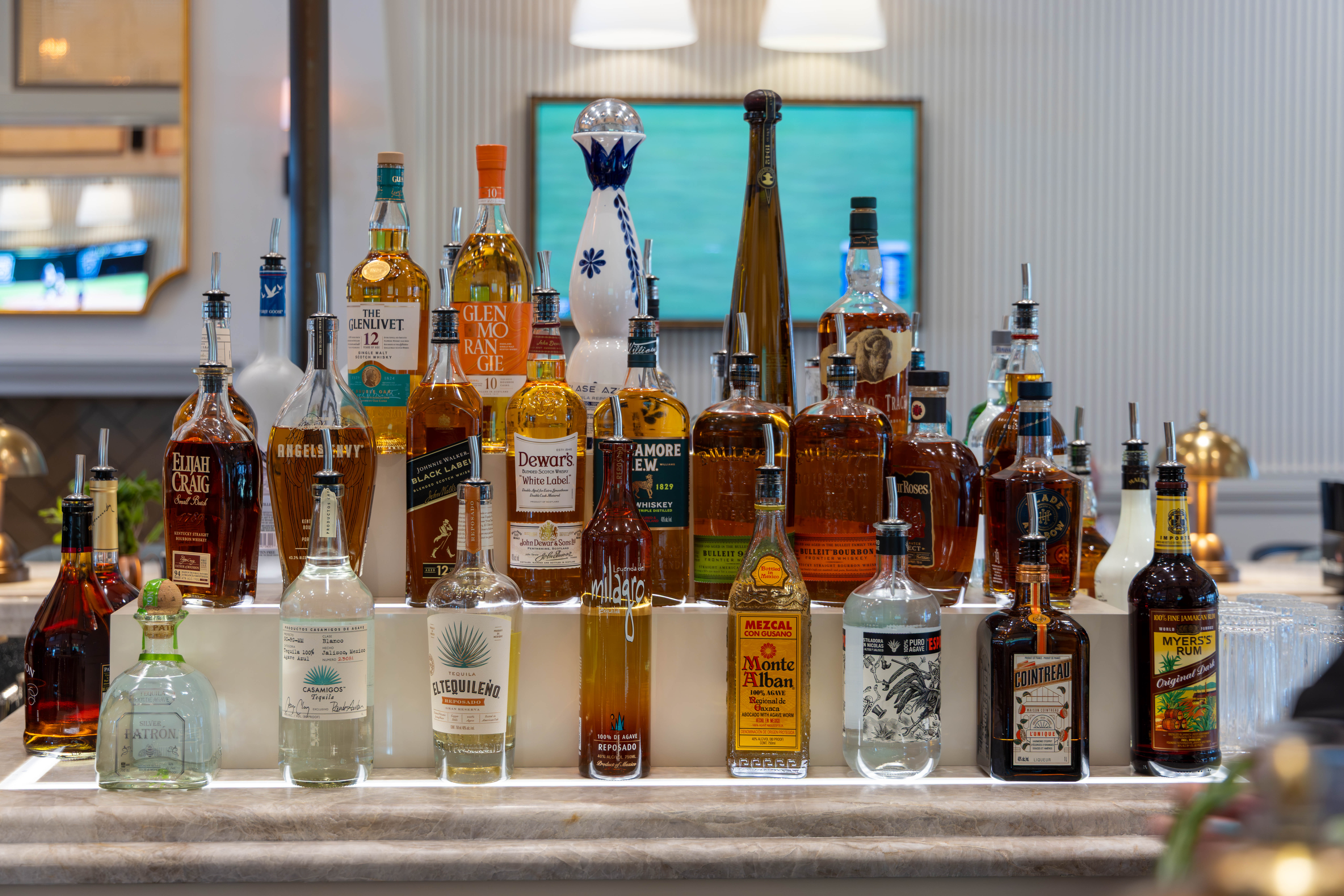 Pizza plate at Brickwood with cocktail and salmon dish in background