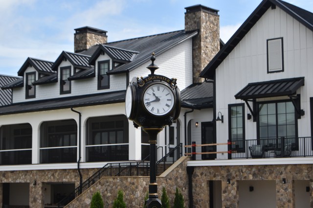 Grandfather clock post with the clubhouse in the background